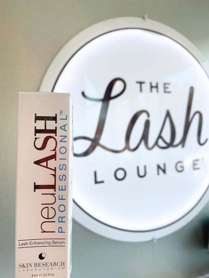 lash serum packed with Lash Lounge log in background