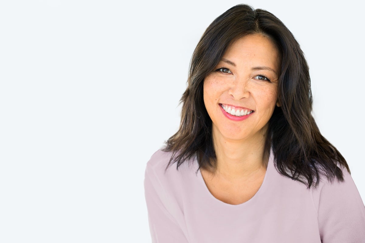 Asian woman smiling with a lash tint