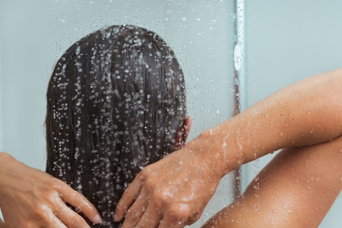 back of woman's head as she showers