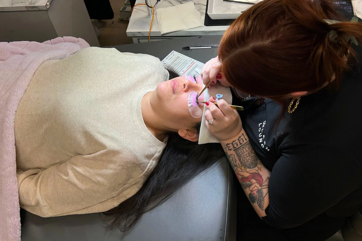 lash artist working on a guest