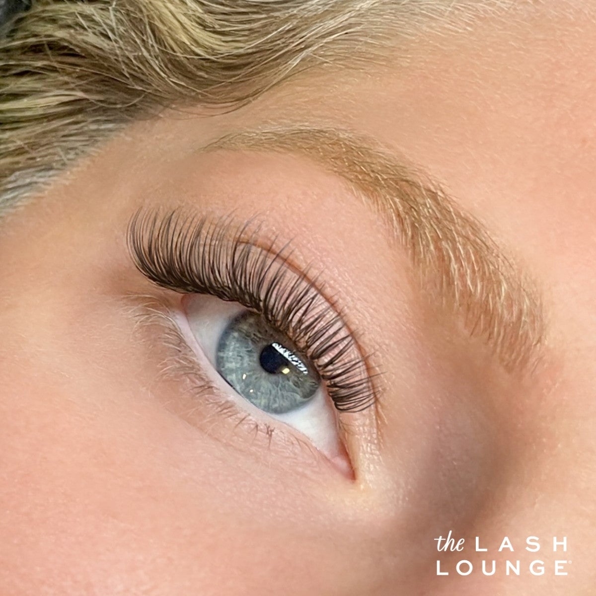 Up close image of blue eye with eyelash extensions.