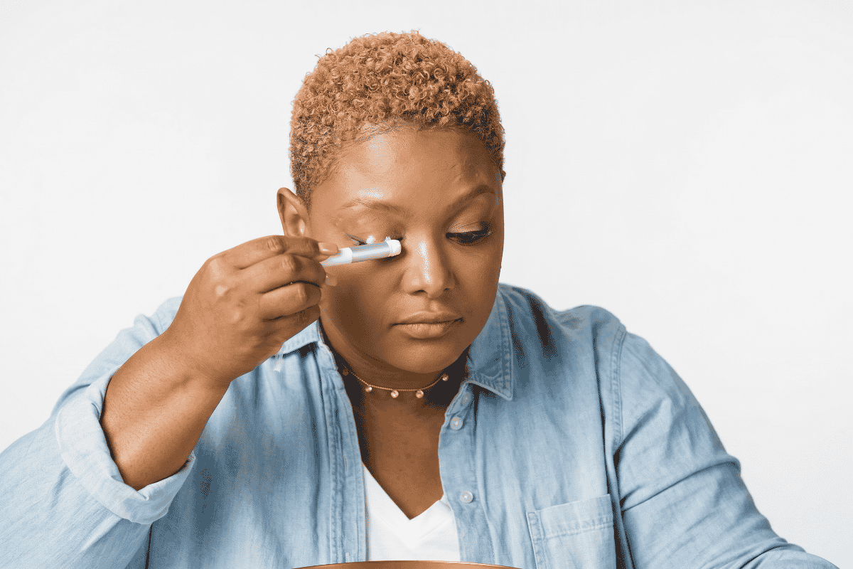 Woman cleansing her lash extensions.