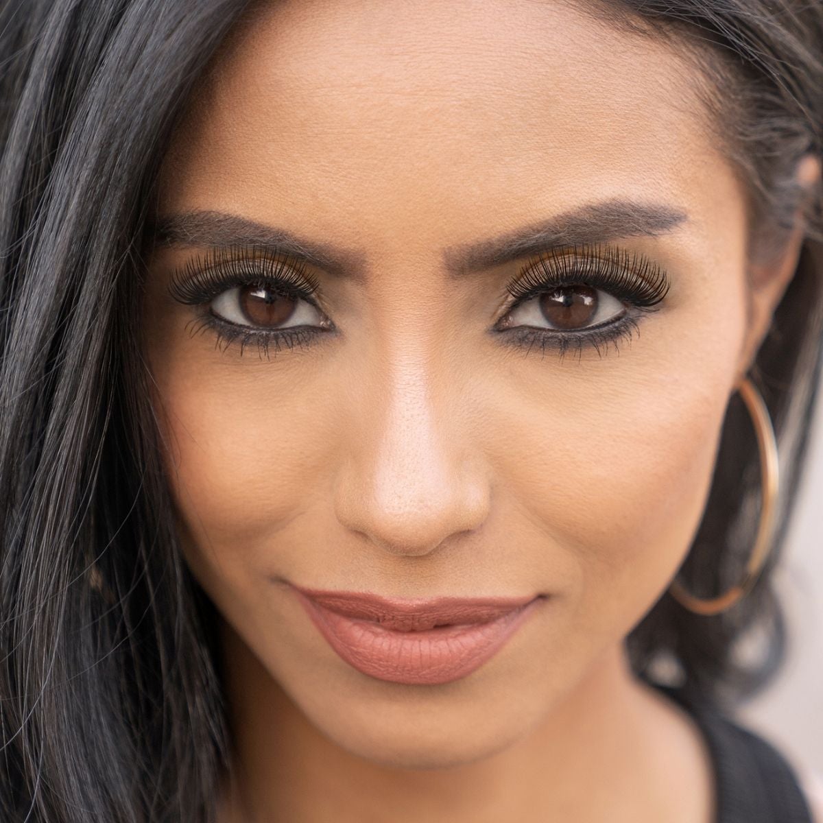 Woman with lash extensions wearing eyeliner.