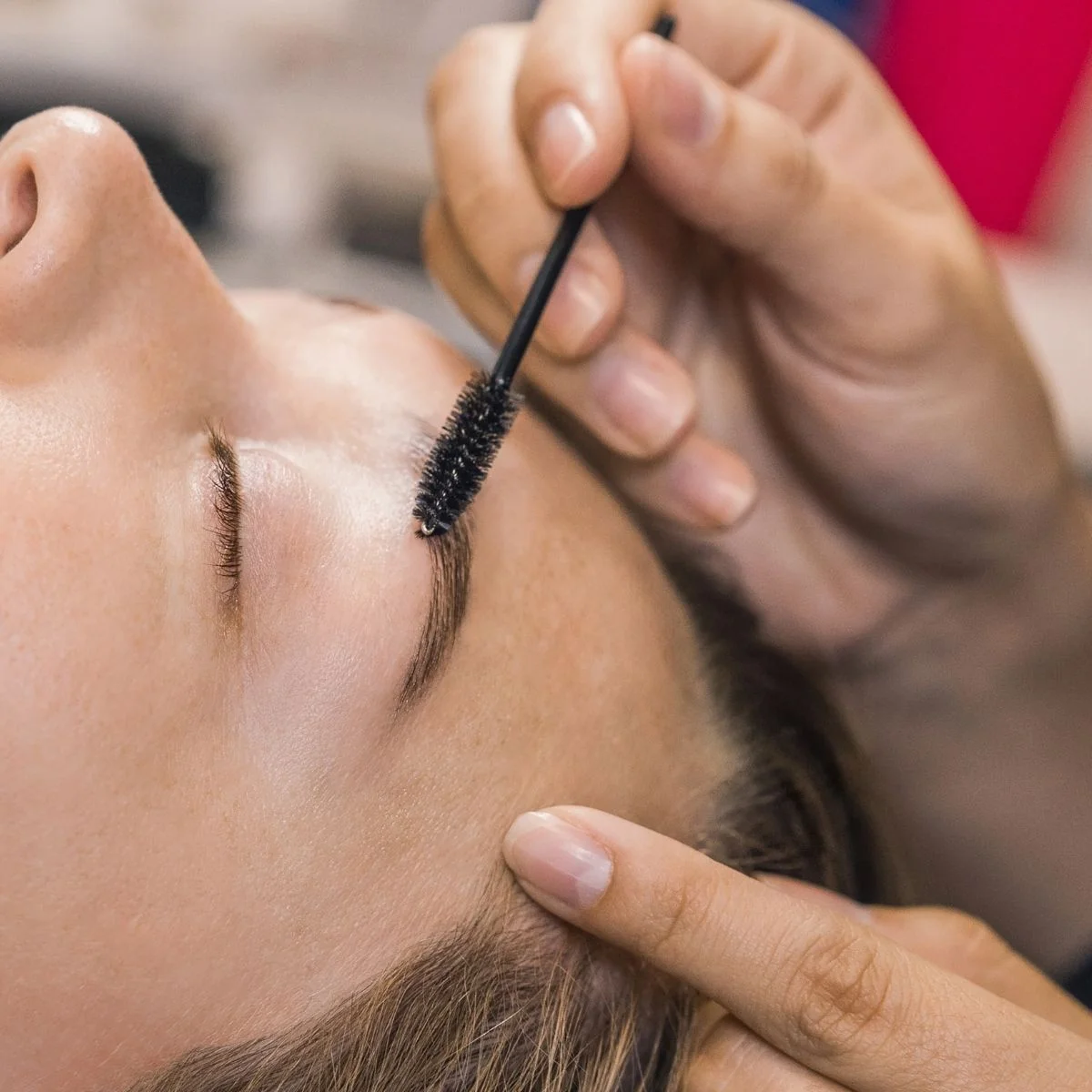 Woman at The Lash Lounge in the middle of eyebrow service.