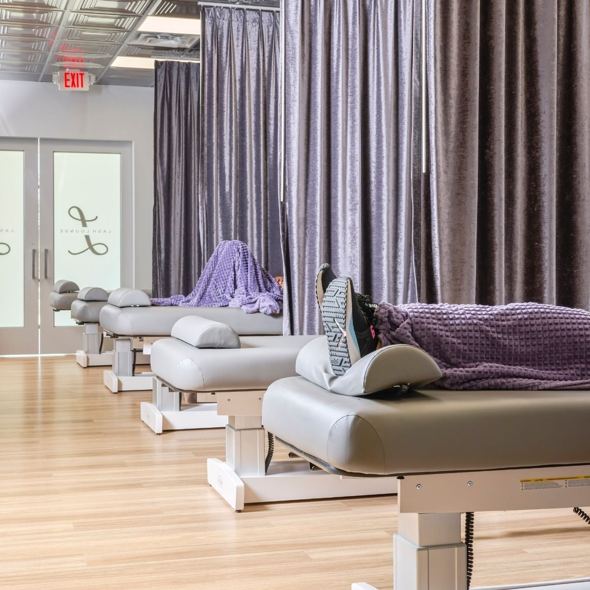 Guests laying in lash beds at The Lash Lounge